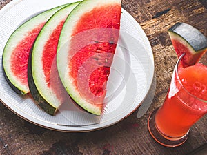 Sliced Watermelon on white plate with spoon and fork stock photo with white background.