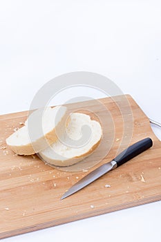 Sliced white bread and knife on the cutting board