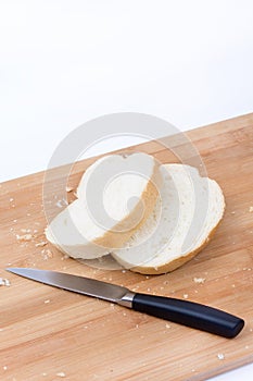 Sliced white bread and knife on the cutting board