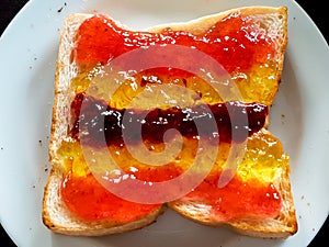 Sliced white bread with variety jam on top