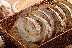 Sliced white bread with wheat flour on a wooden table. Chamado PÃÂ£o de forma