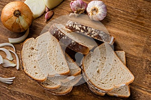 Sliced white bread with wheat flour on a wooden table. Chamado PÃ£o de forma