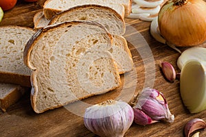 Sliced white bread with wheat flour on a wooden table. Chamado PÃ£o de forma