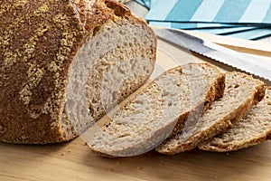 Sliced whole fresh baked German dinkel wheat bread on a cutting board