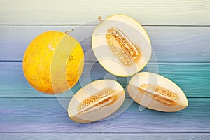 Sliced yellow melon on wood