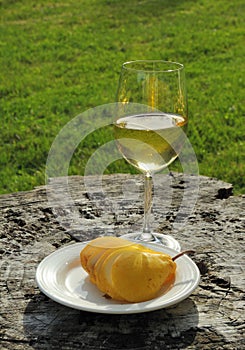 Sliced yellow pear and glass of wine