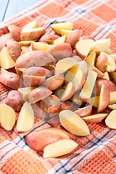 Sliced young potatoes drying on the kitchen dishcloth