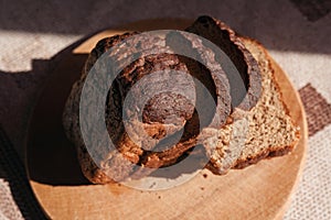 Sliced â€‹â€‹black rye bread on a wooden board. Brick-shaped bread