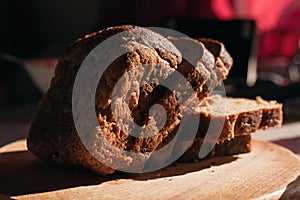 Sliced â€‹â€‹black rye bread on a wooden board. Brick-shaped bread