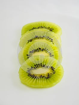 Sliced â€‹â€‹kiwi fruit on white background, close-up photo of a kiwi, raw green fruit