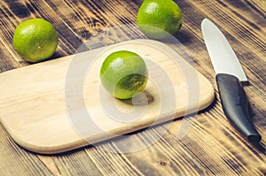 Sliced â€‹â€‹limes with a white bladed knife