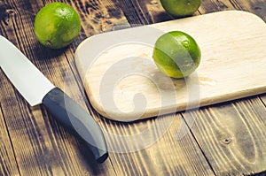 Sliced â€‹â€‹limes with a white bladed knife