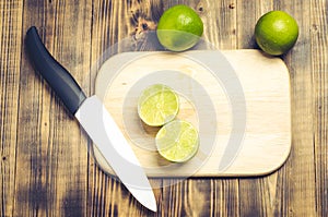 Sliced â€‹â€‹limes on a wooden kitchen table