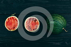 Sliced â€‹â€‹little fresh watermelon on a dark background. Summer fruit