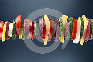 Sliced â€‹â€‹pieces of sausage, salami, cheese, cucumber and tomato. fast food. ingredients for pizza. calories and diet