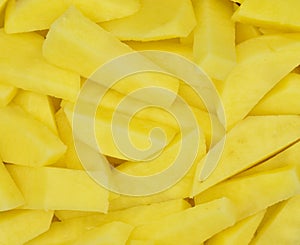 Sliced â€‹â€‹potatoes in purple plastic colander