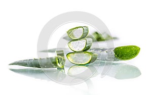 Slices of aloe vera with gel on white background