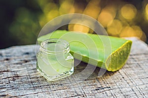 Slices of a aloe vera leaf and a bottle with transparent gel for medicinal purposes, skin treatment and cosmetics, close