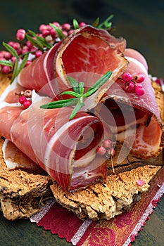 Slices of Alto Adige speck rolled with wild red pepper