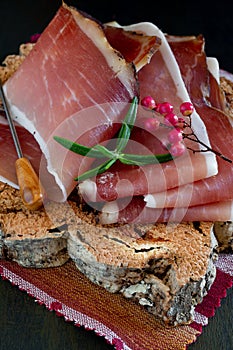 Slices of Alto Adige speck rolled with wild red pepper