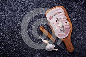 Slices of bacon with pepper and garlic