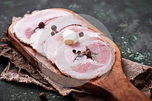 Slices of bacon with pepper and garlic