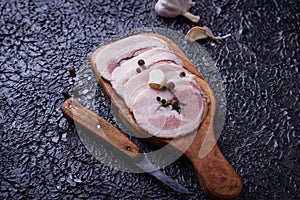 Slices of bacon with pepper and garlic