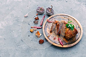 Slices of beef steak with spices on blue table photo