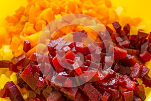 Slices of boiled red beat and carrots on a wooden board