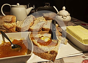 Slices of bread, butter and peach jam for breakfast