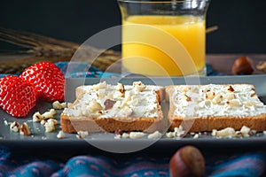 Slices of bread with cream cheese, strawberries and juice