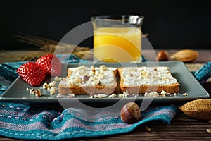 Slices of bread with cream cheese, strawberries and juice photo