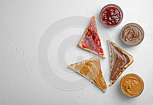 Slices of bread with different spreads on  table, flat lay. Space for text