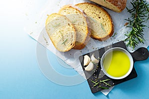 Slices of bread on papyrine with garlic, olive oil and Rosemarie. photo