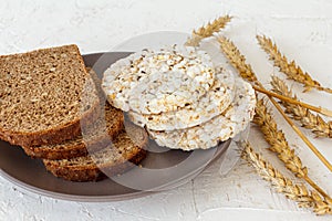 Slices of bread and puffed rice cakes on plate