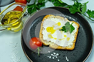 Slices of bread, sandwiches, red tomatoes, salt shaker, greens. The concept of making breakfast or a snack from organic farm
