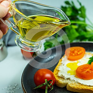 Slices of bread, sandwiches, red tomatoes, salt shaker, greens. The concept of making breakfast or a snack from organic farm