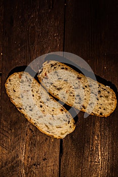 Slices of brown bread on a wooden table.fitness bread with bran and cereals