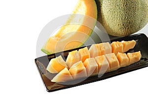 Slices cantaloupe melon fruit in blackdish.