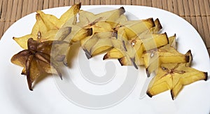 Slices of carambola isolated on a white plate