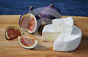 Slices of cheese Bree and figs, close up