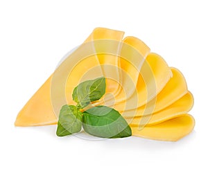 Slices of cheese with fresh basil leaves close-up isolated on a white background.