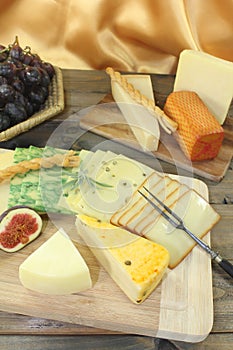 Slices of cheese with grapes and figs