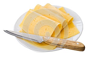 Slices of cheese, kitchen knife in glass plate isolated on white