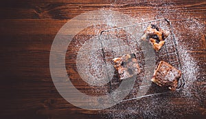 Slices of cherry cake on a cooling hatch with cake in a pan in a background.