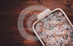 Slices of cherry cake on a cooling hatch with cake in a pan in a background.