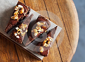 Slices of chocolate cake sitting on a bakery serving board