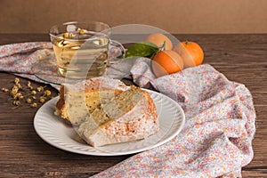 Slices of clementine cake with powdered sugar topping and cup of