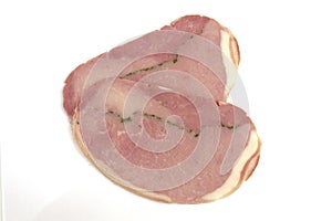 Slices of cooked ham on a white background