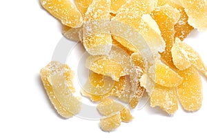 Slices of crystallized ginger in sugar isolated on white
